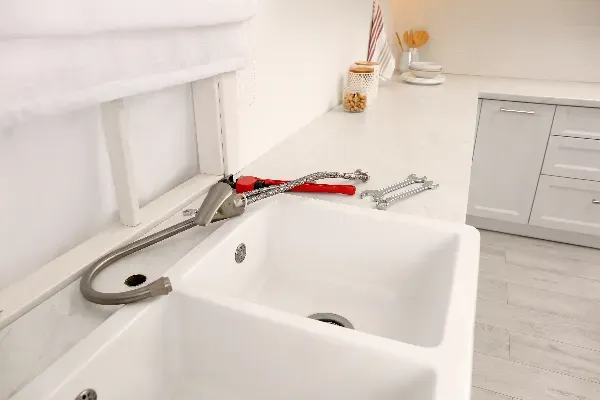 Kitchen sink and faucet connected after a remodel